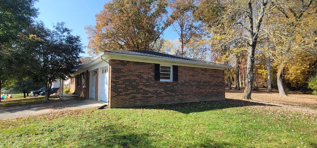 view of property exterior with a garage and a yard