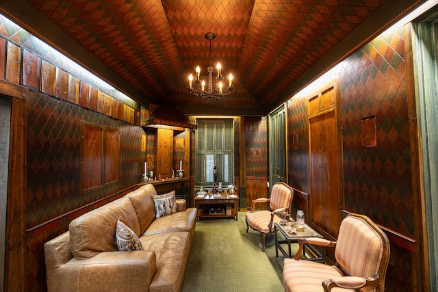 living area with wooden walls, a chandelier, and vaulted ceiling