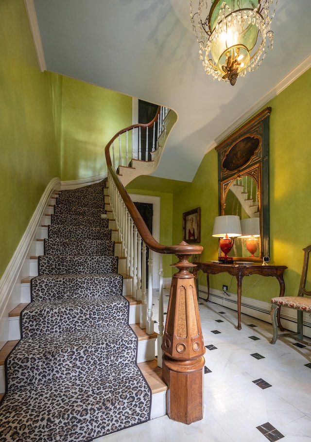 stairway with a notable chandelier and crown molding