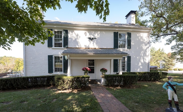 3521 Bryan Station Rd, Lexington, KY 40516 - view of front of property featuring brick siding, a chimney, and a front yard