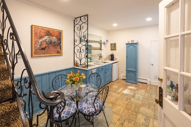 dining area featuring baseboard heating and crown molding