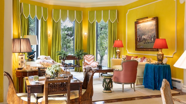 sitting room with ornamental molding, a baseboard radiator, and carpet floors