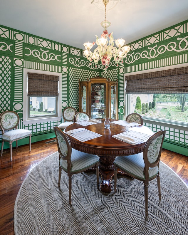 dining area with a notable chandelier and hardwood / wood-style flooring