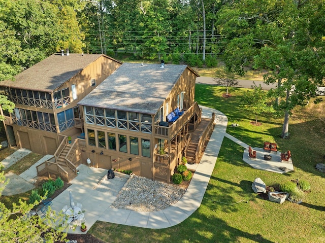 rear view of house with a lawn and a patio