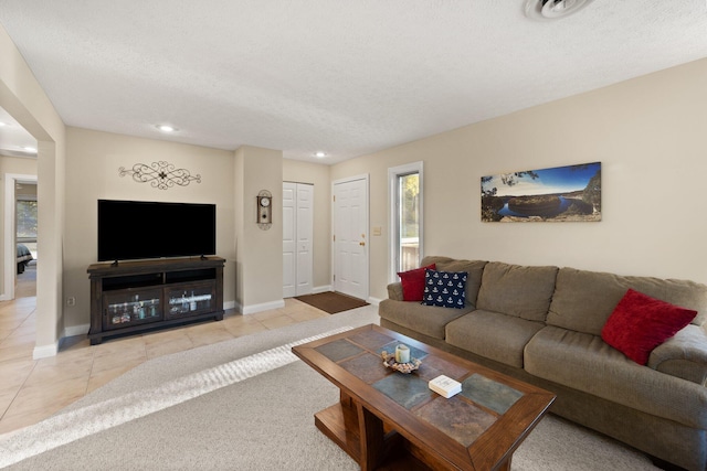 tiled living room with a textured ceiling