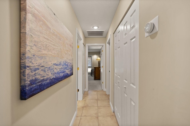 hall with light tile patterned flooring