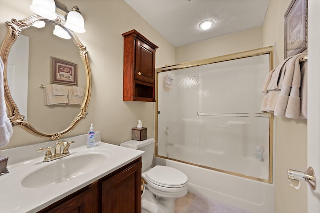 full bathroom with a textured ceiling, combined bath / shower with glass door, vanity, and toilet