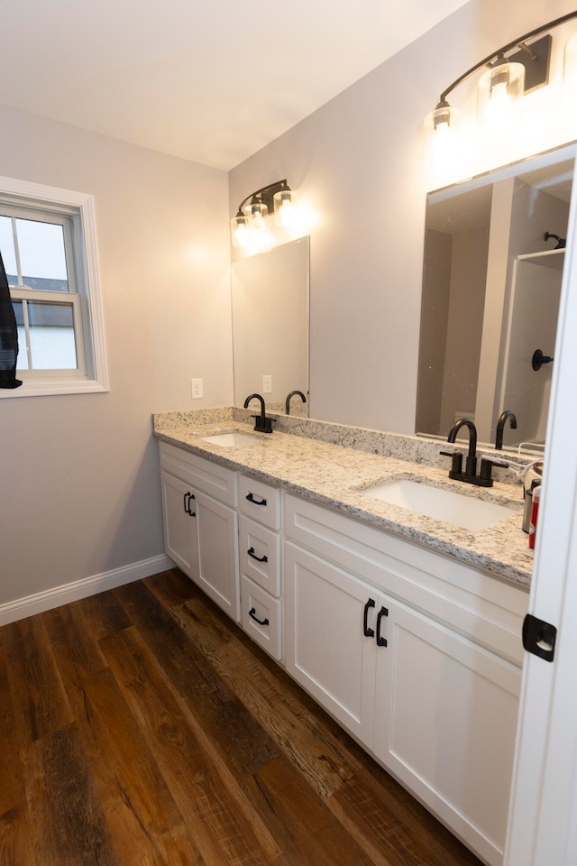 bathroom with hardwood / wood-style flooring and vanity