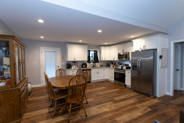 kitchen with dark hardwood / wood-style floors, white cabinetry, and appliances with stainless steel finishes