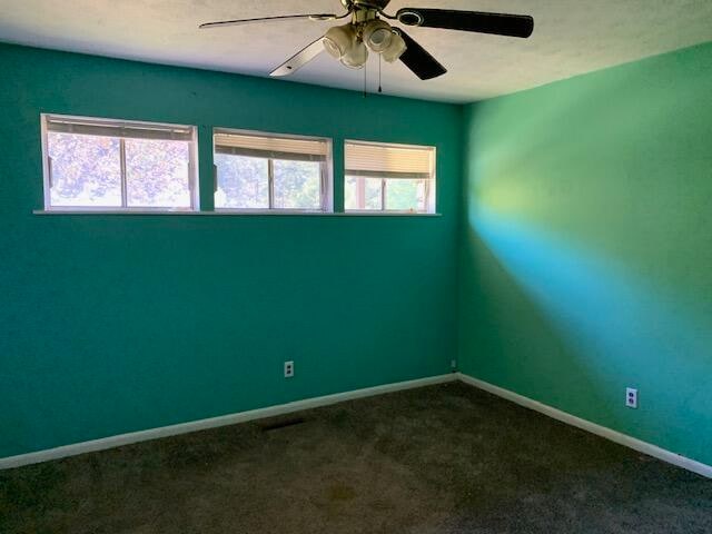 empty room with carpet, ceiling fan, and plenty of natural light