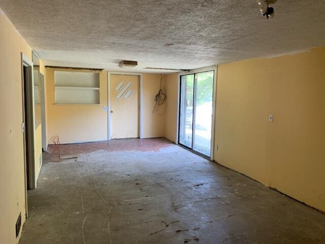 spare room with a textured ceiling