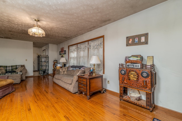 living room with a textured ceiling and hardwood / wood-style flooring