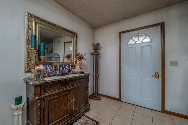 tiled foyer with a textured ceiling