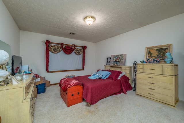 carpeted bedroom with a textured ceiling