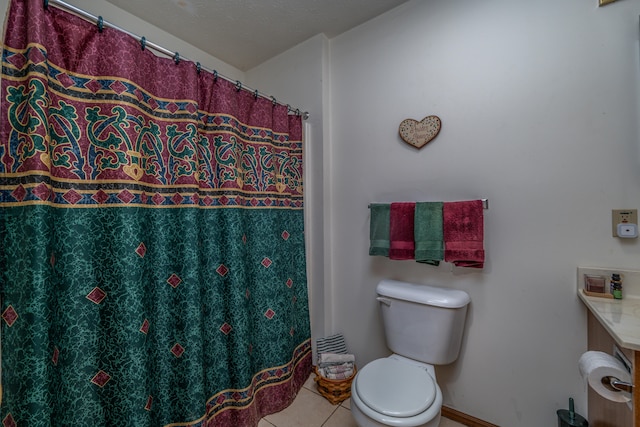 bathroom featuring tile patterned flooring, vanity, and toilet