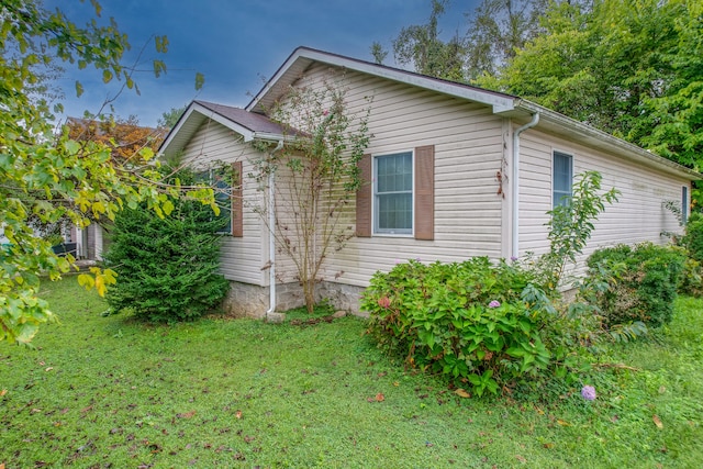 view of home's exterior featuring a lawn