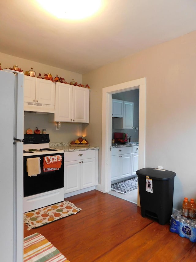 kitchen featuring white appliances, white cabinetry, and dark hardwood / wood-style floors