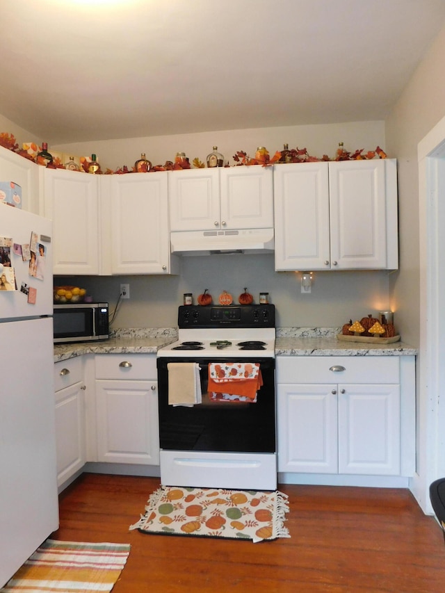 kitchen with light stone countertops, white cabinets, white appliances, and hardwood / wood-style flooring