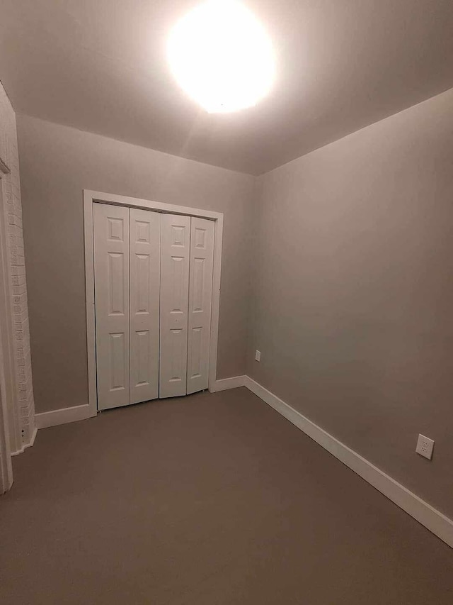 unfurnished bedroom with a closet and carpet flooring