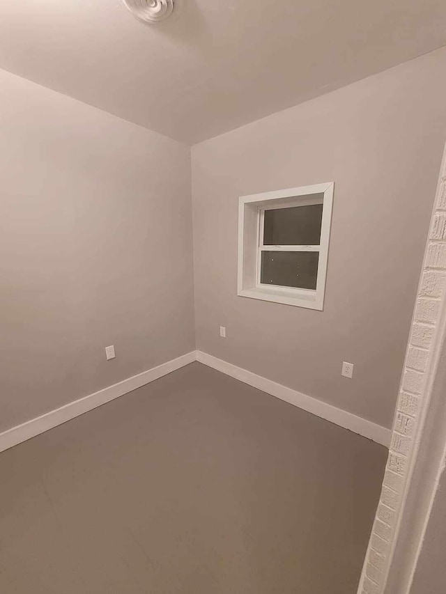 unfurnished room with concrete flooring