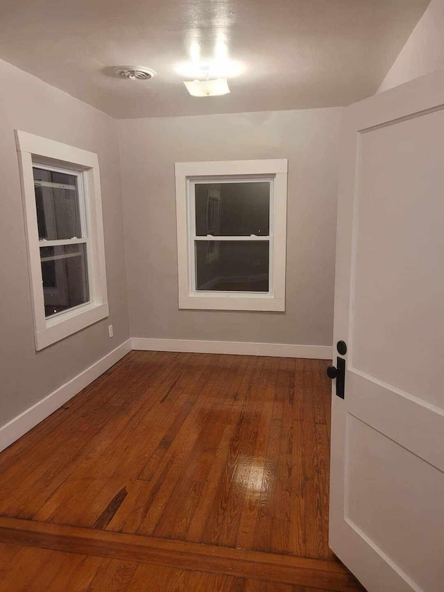 spare room with hardwood / wood-style flooring