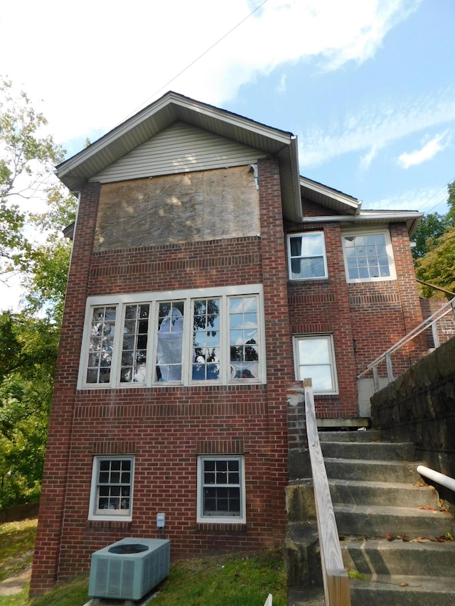 rear view of property featuring central AC