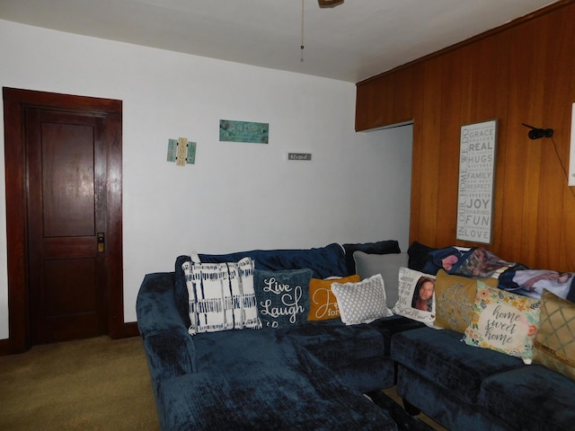 living room featuring wood walls and carpet flooring