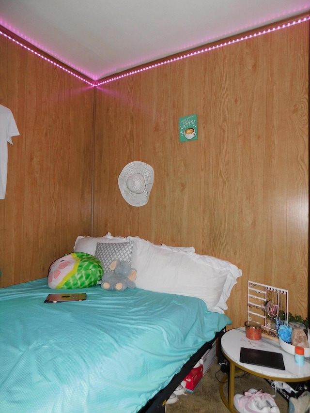 bedroom featuring wooden walls