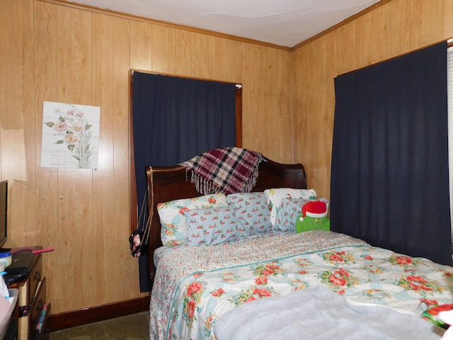 carpeted bedroom with wood walls