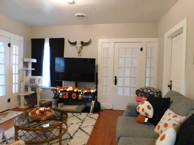 living room featuring a multi sided fireplace and dark wood-type flooring