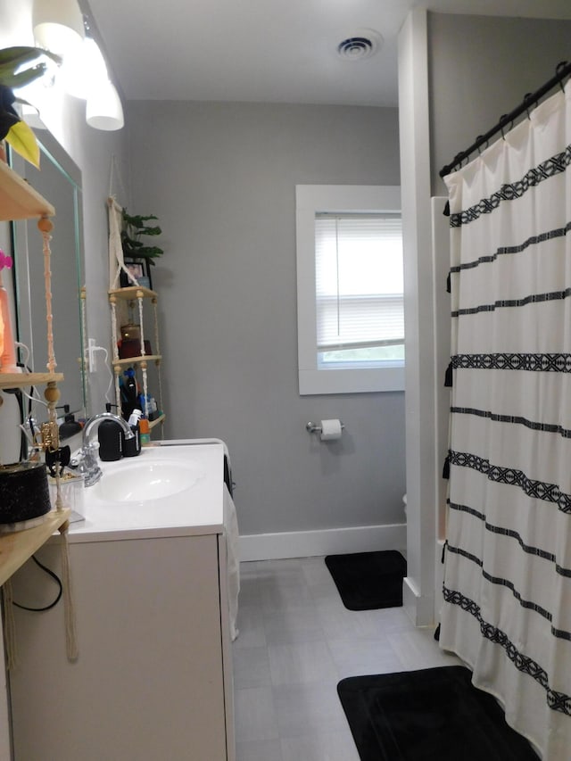 bathroom with vanity, toilet, and curtained shower