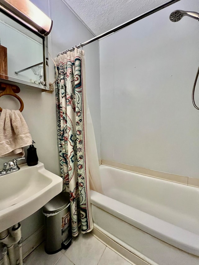 bathroom featuring tile patterned floors, shower / bath combination with curtain, and a textured ceiling