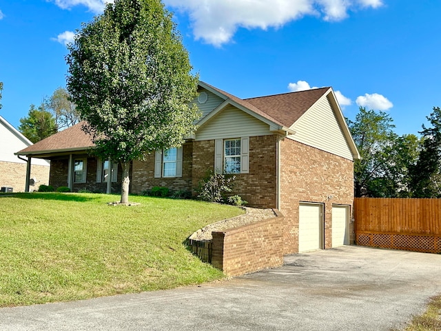 view of front of home with a front lawn and a garage