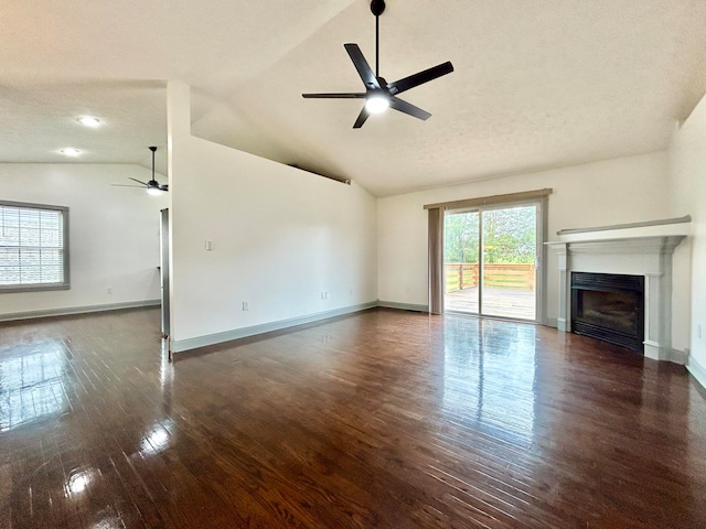 unfurnished living room featuring vaulted ceiling, a textured ceiling, ceiling fan, and dark hardwood / wood-style flooring