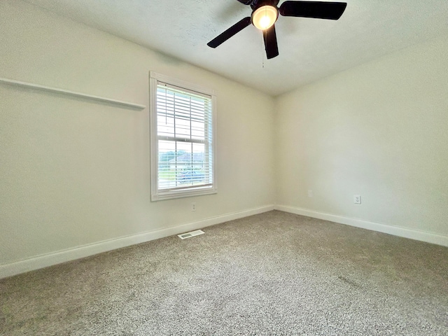 carpeted spare room with ceiling fan and a textured ceiling