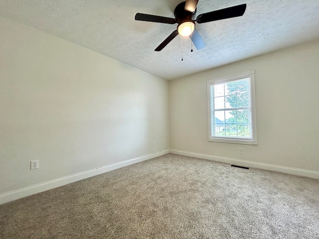 carpeted empty room featuring a textured ceiling and ceiling fan