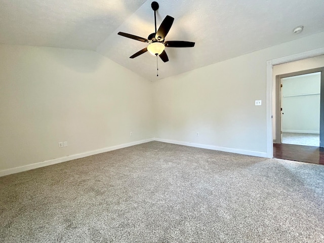 carpeted spare room with lofted ceiling, ceiling fan, and a textured ceiling