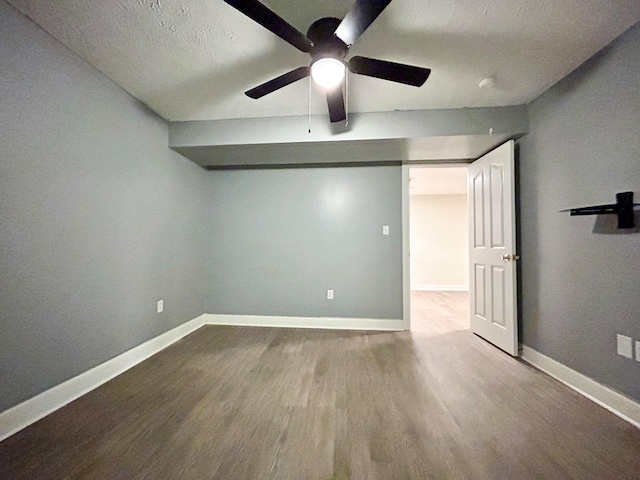 unfurnished room featuring wood-type flooring, ceiling fan, and a textured ceiling