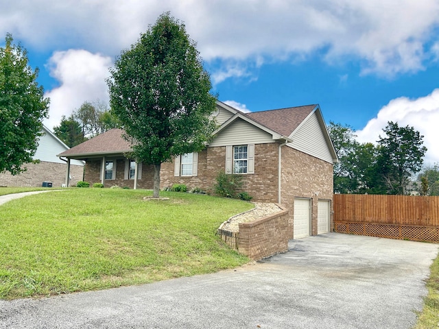 view of front of property with a front yard and a garage