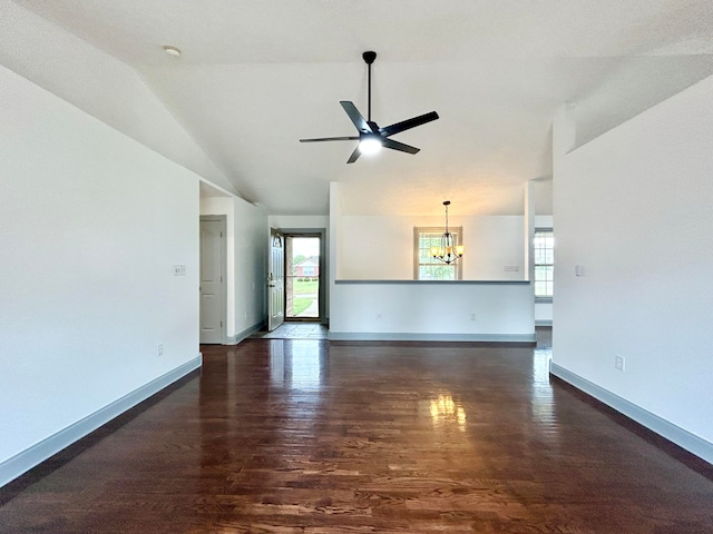 unfurnished living room featuring ceiling fan with notable chandelier, lofted ceiling, and dark hardwood / wood-style flooring