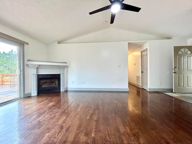 unfurnished living room with a textured ceiling, lofted ceiling, ceiling fan, and dark hardwood / wood-style flooring