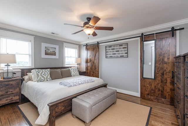 bedroom with wood-type flooring, multiple windows, and ceiling fan