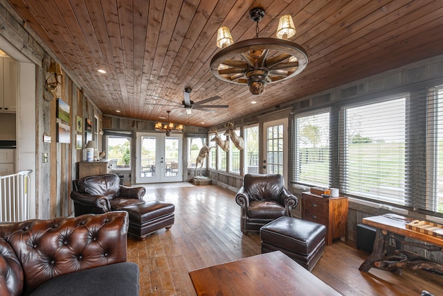 sunroom / solarium featuring french doors, ceiling fan, wooden ceiling, and a healthy amount of sunlight