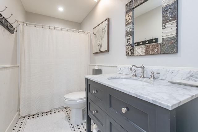 bathroom with walk in shower, tile patterned flooring, vanity, and toilet