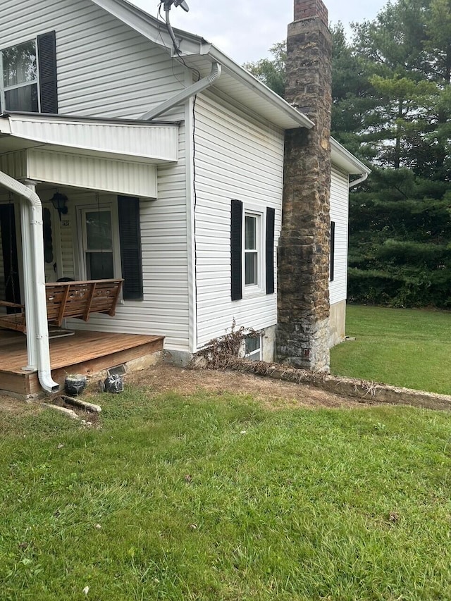 view of side of property with a yard