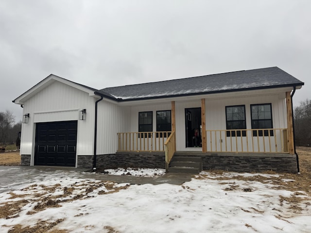 view of front of property featuring a garage and a porch