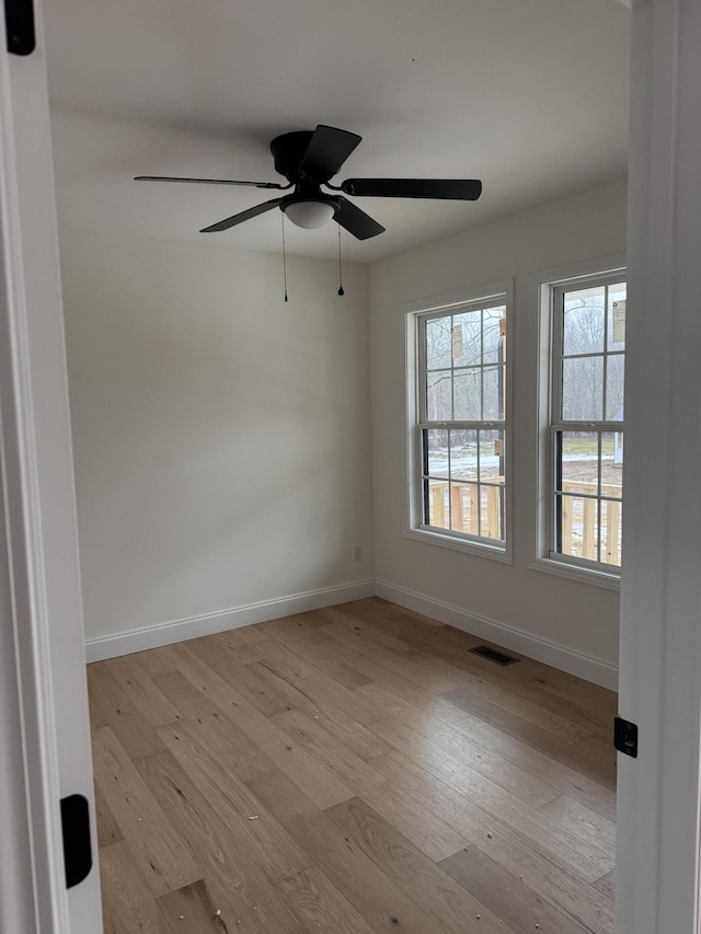 spare room with ceiling fan and light hardwood / wood-style floors