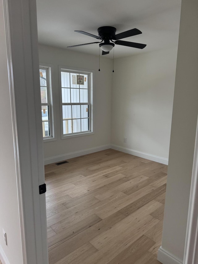 unfurnished room featuring ceiling fan and light wood-type flooring