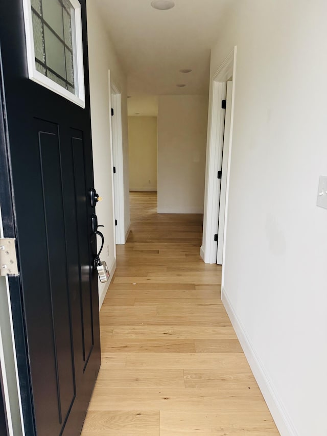 hall with light hardwood / wood-style flooring