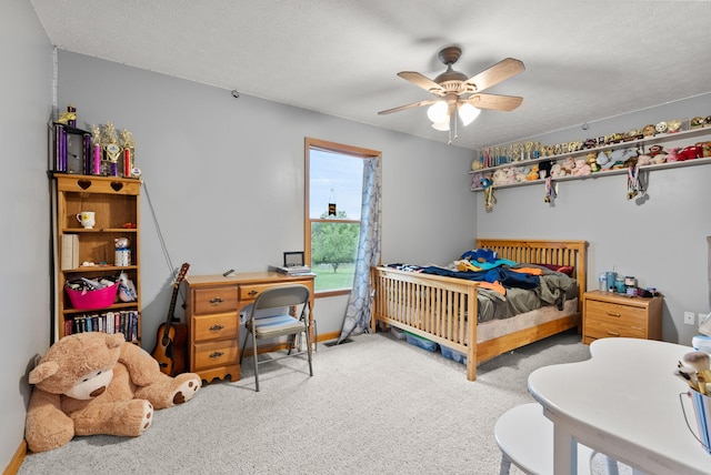 bedroom featuring ceiling fan, a textured ceiling, and carpet flooring